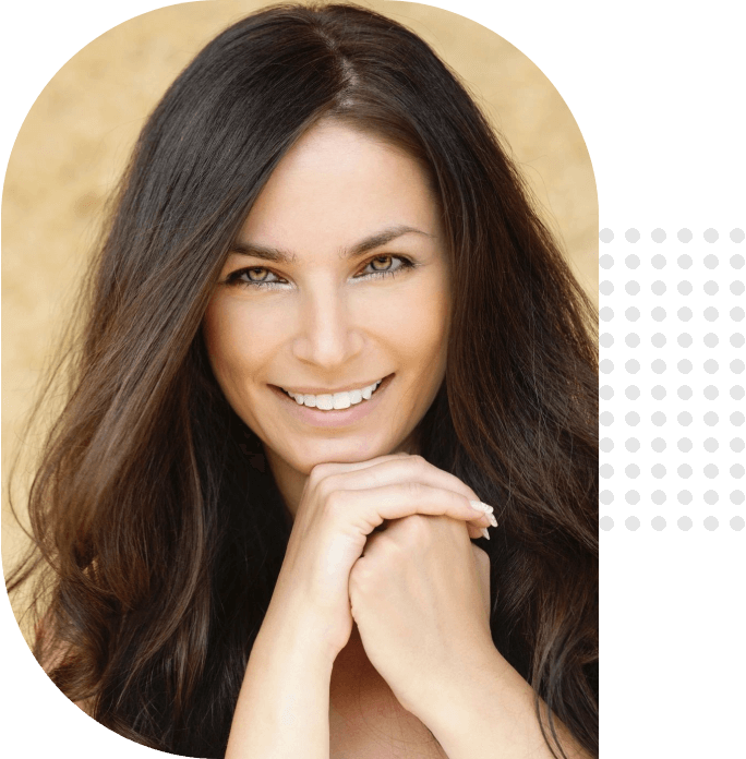 A woman with long hair smiles for the camera.